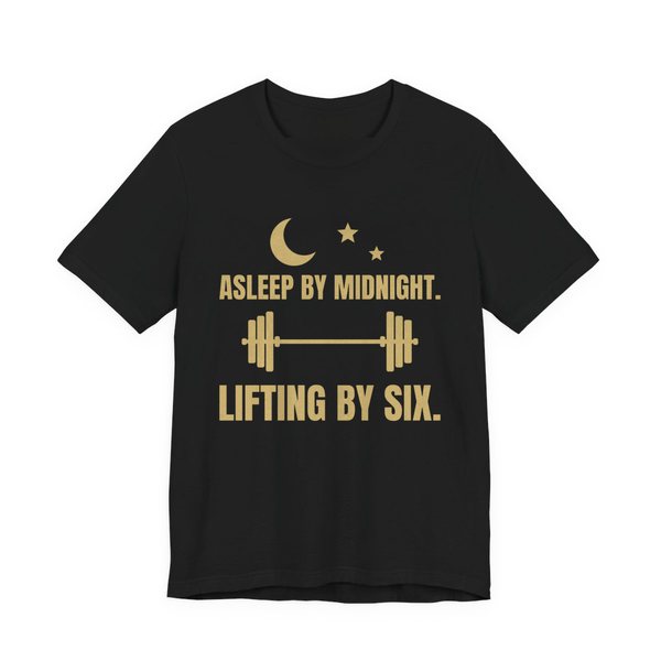 Black t-shirt printed in champagne gold ink with a moon and stars, a barbell and the words “Asleep by Midnight. Lifting by Six.”