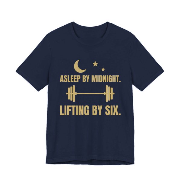 Navy t-shirt printed in champagne gold ink with a moon and stars, a barbell and the words “Asleep by Midnight. Lifting by Six.”