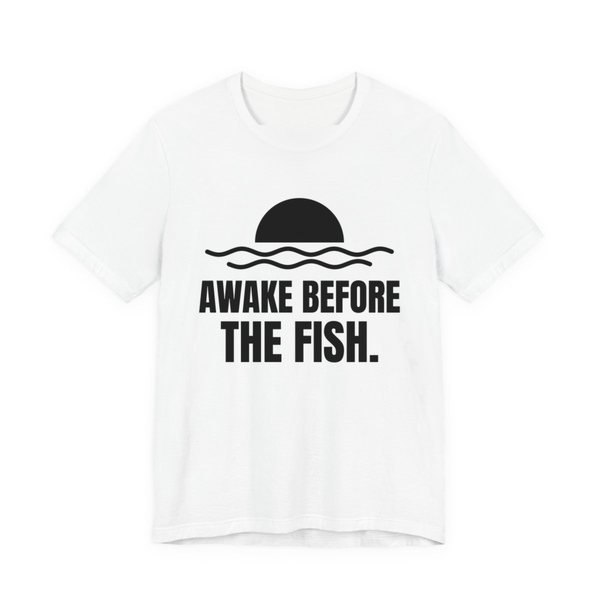 White t-shirt printed in dark ink with a sun rising over the water and the words “Awake Before the Fish.”