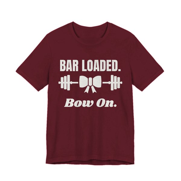 Maroon t-shirt printed in off-white ink with a barbell tied with a bow and the words "Bar Loaded. Bow On."