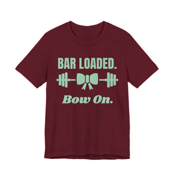 Maroon t-shirt printed in mint green ink with a barbell tied with a bow and the words "Bar Loaded. Bow On."