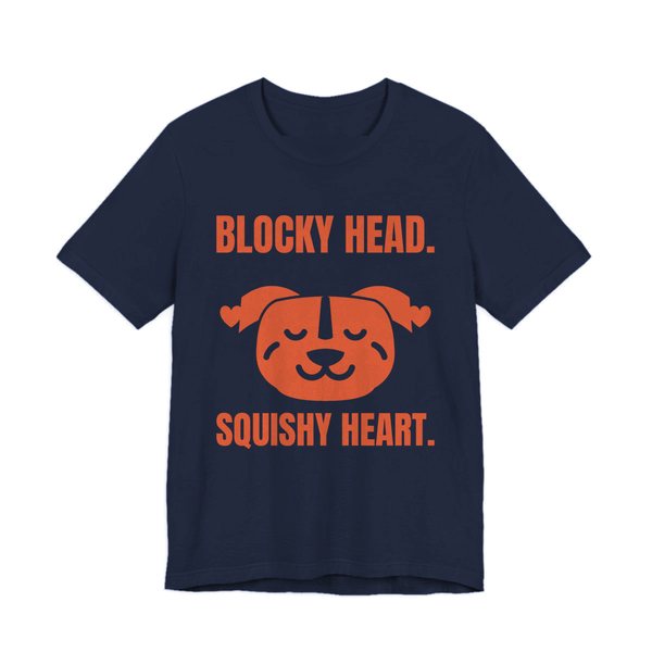 Navy t-shirt printed in orange ink with a pit bull face with hearts and the words “Blocky Head. Squishy Heart.”