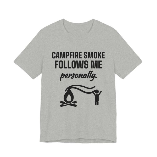 Athletic Heather t-shirt printed in dark ink with a campfire whose smoke trails after a little stick figure and the words “Campfire Smoke Follows Me Personally.”
