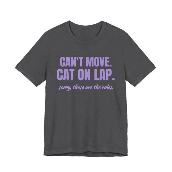 Dark Grey Heather t-shirt printed in lavender ink with the words “Can't Move. Cat on Lap.”