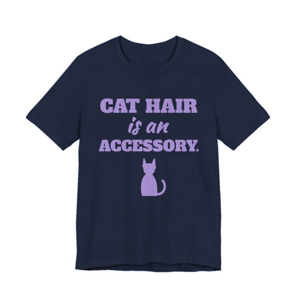 Navy t-shirt printed in lavender ink with a cat silhouette and the words “Cat Hair Is an Accessory.”