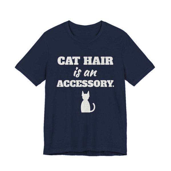 Navy t-shirt printed in off-white ink with a cat silhouette and the words “Cat Hair Is an Accessory.”
