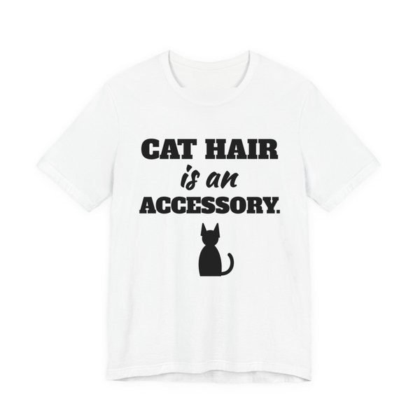White t-shirt printed in dark ink with a cat silhouette and the words “Cat Hair Is an Accessory.”