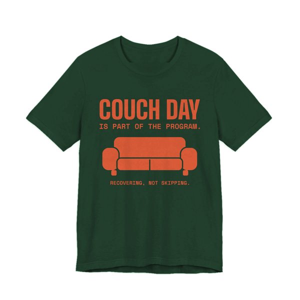 Forest t-shirt printed in orange ink with a couch and the words “Couch Day Is Part of the Program. Recovering, Not Skipping.”