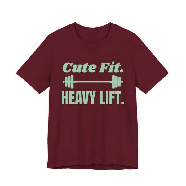 Maroon t-shirt printed in mint green ink with a barbell between the words "Cute Fit." and "Heavy Lift."