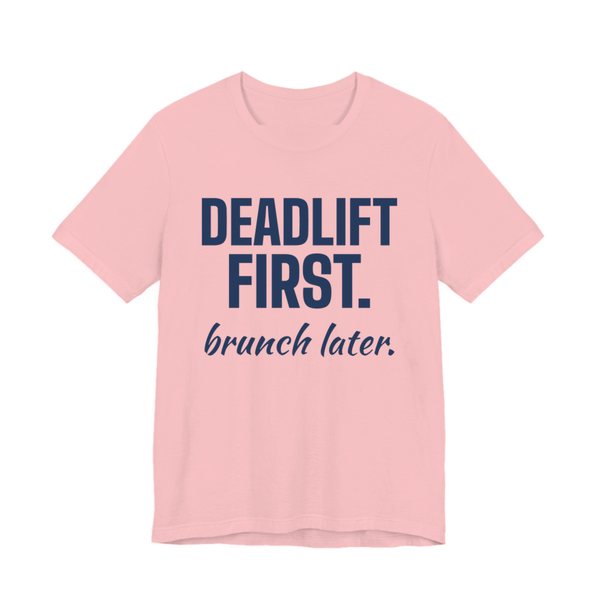 Pink t-shirt printed in navy blue ink with the words "Deadlift First. Brunch Later."