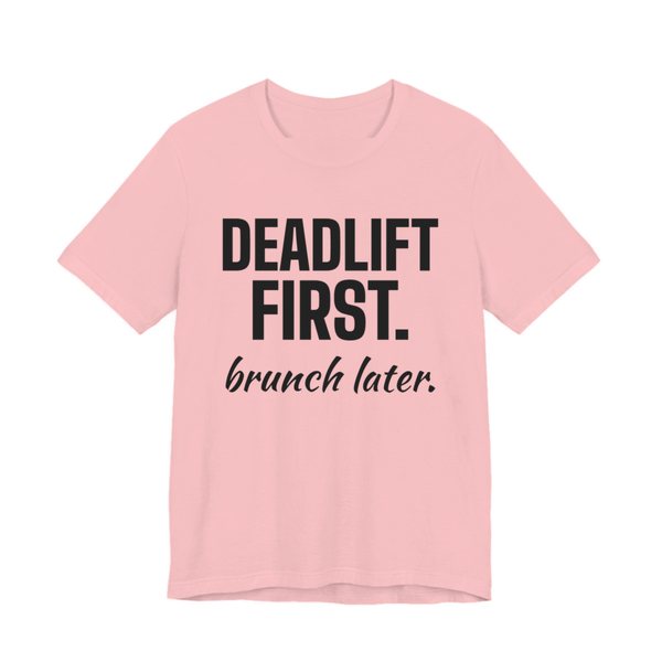 Pink t-shirt printed in dark ink with the words "Deadlift First. Brunch Later."