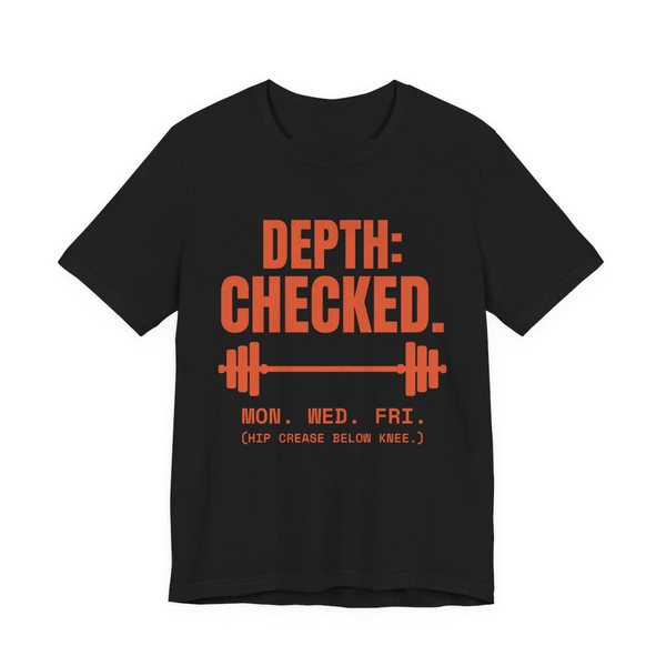 Black t-shirt printed in orange ink with a barbell and the words “Depth: Checked. Mon. Wed. Fri. (Hip crease below knee.)”