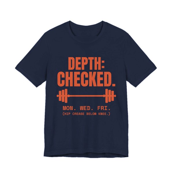 Navy t-shirt printed in orange ink with a barbell and the words “Depth: Checked. Mon. Wed. Fri. (Hip crease below knee.)”
