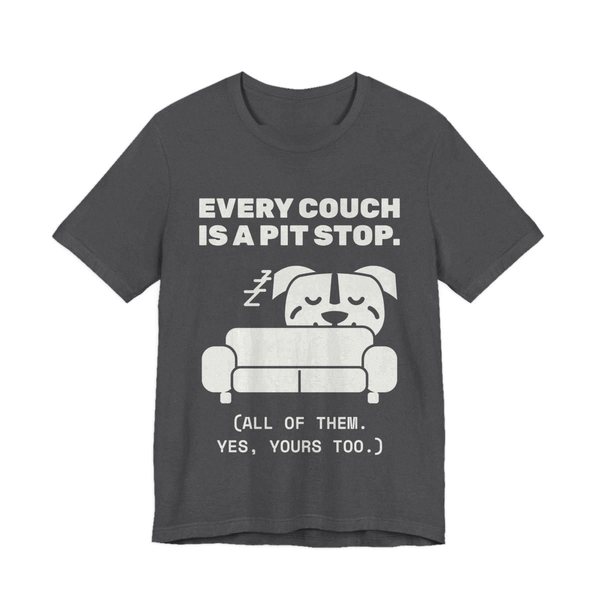 Dark Grey Heather t-shirt printed in off-white ink with a pit bull napping on a couch and the words “Every Couch Is a Pit Stop. (All of them. Yes, yours too.)”