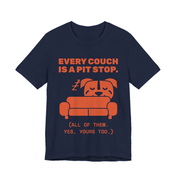 Navy t-shirt printed in orange ink with a pit bull napping on a couch and the words “Every Couch Is a Pit Stop. (All of them. Yes, yours too.)”