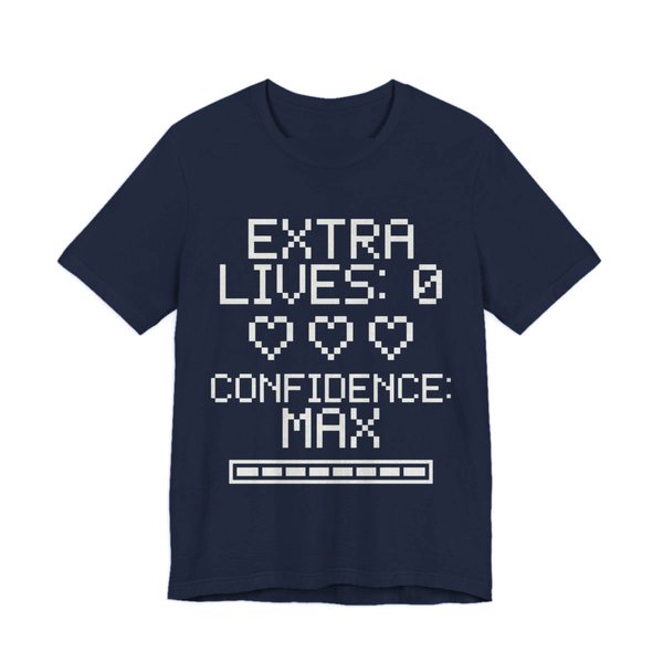 Navy t-shirt printed in off-white ink with three empty pixel hearts, a full meter and the words “Extra Lives: 0. Confidence: Max.”