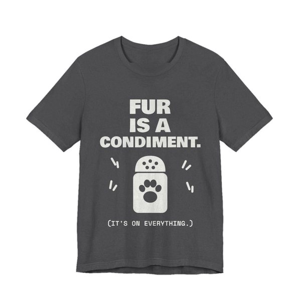 Dark Grey Heather t-shirt printed in off-white ink with a shaker with a paw print and the words “Fur Is a Condiment. (It's on everything.)”