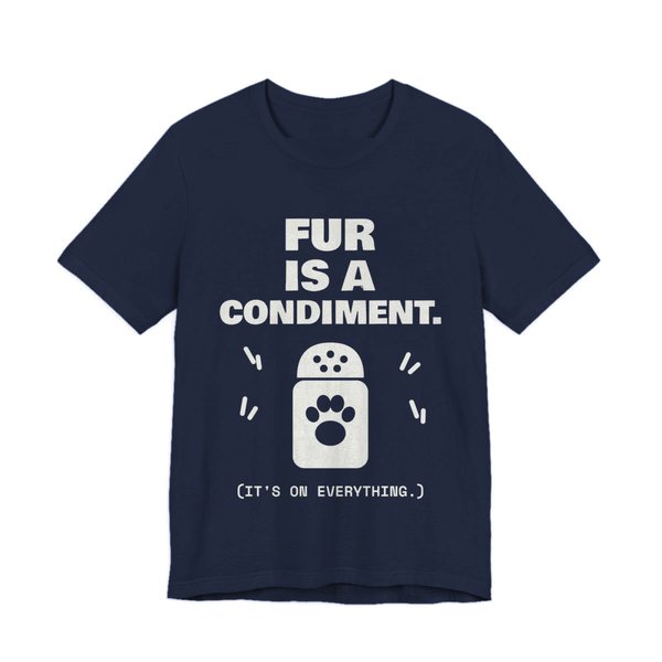 Navy t-shirt printed in off-white ink with a shaker with a paw print and the words “Fur Is a Condiment. (It's on everything.)”