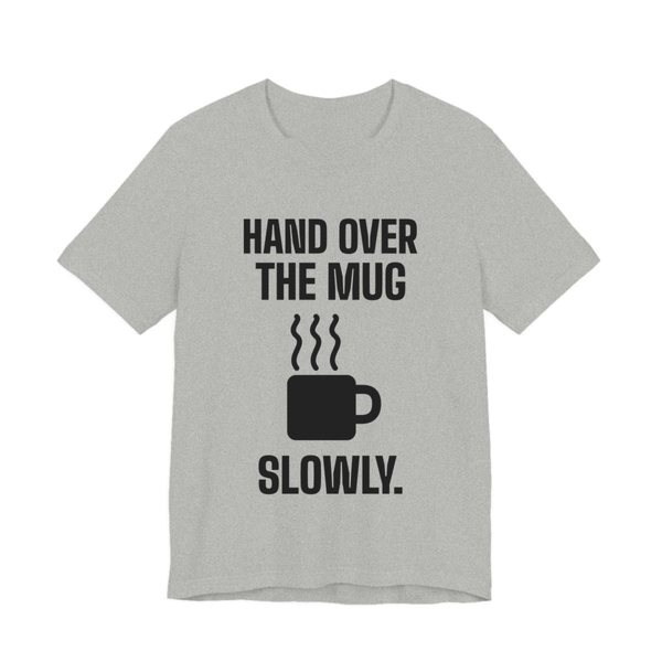 Athletic Heather t-shirt printed in dark ink with a steaming mug and the words “Hand Over the Mug Slowly.”