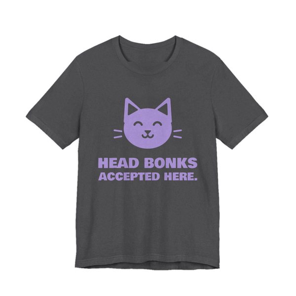 Dark Grey Heather t-shirt printed in lavender ink with a cat face and the words “Head Bonks Accepted Here.”