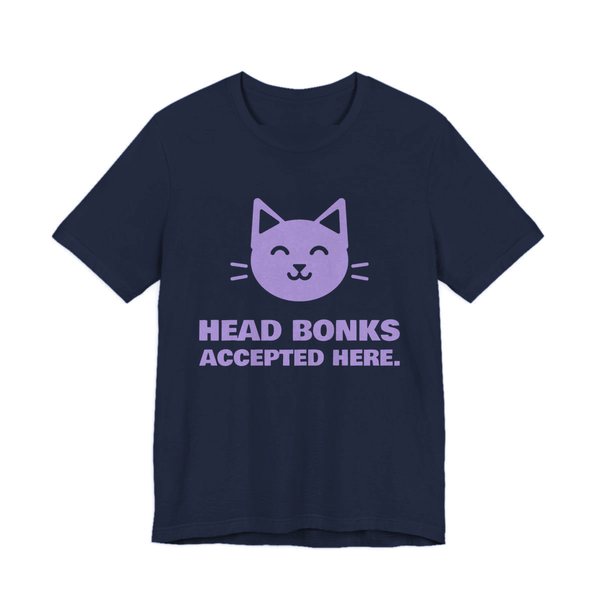 Navy t-shirt printed in lavender ink with a cat face and the words “Head Bonks Accepted Here.”