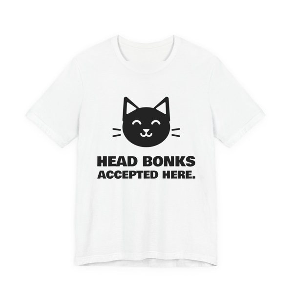 White t-shirt printed in dark ink with a cat face and the words “Head Bonks Accepted Here.”