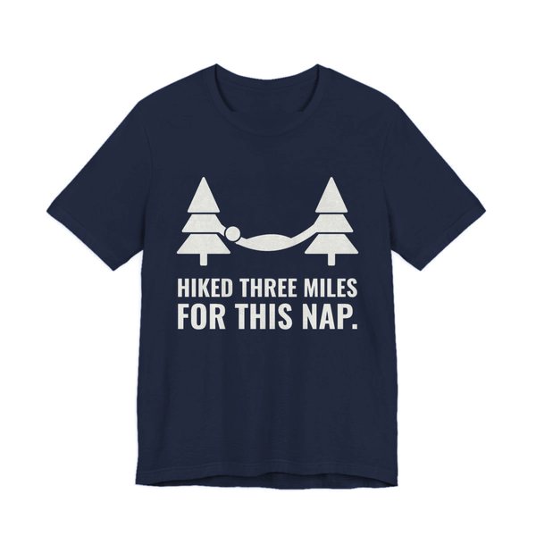 Navy t-shirt printed in off-white ink with a hammock between two pine trees and the words “Hiked Three Miles for This Nap.”