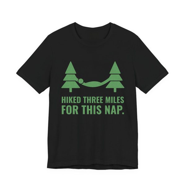 Black t-shirt printed in pine green ink with a hammock between two pine trees and the words “Hiked Three Miles for This Nap.”