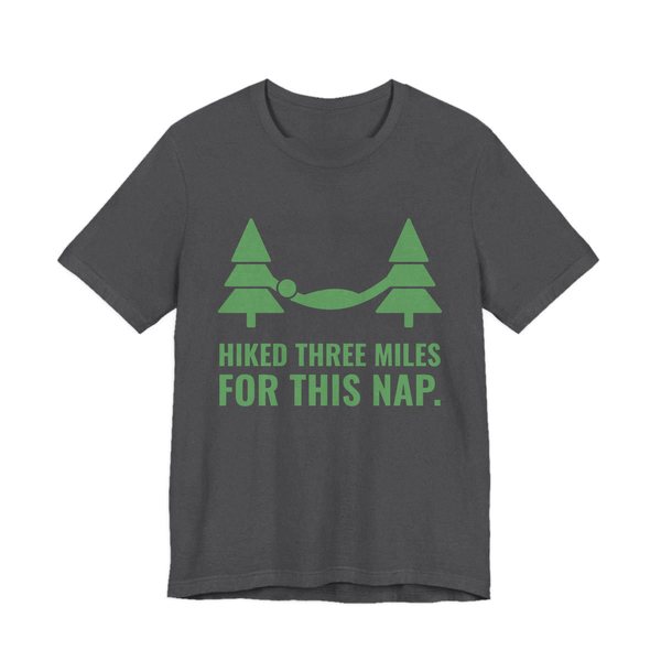 Dark Grey Heather t-shirt printed in pine green ink with a hammock between two pine trees and the words “Hiked Three Miles for This Nap.”