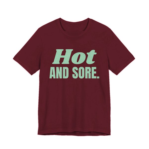 Maroon t-shirt printed in mint green ink with the words "Hot and Sore."
