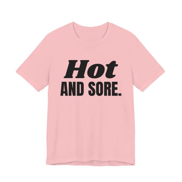 Pink t-shirt printed in dark ink with the words "Hot and Sore."