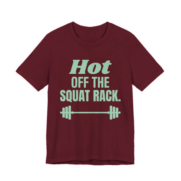 Maroon t-shirt printed in mint green ink with a barbell and the words "Hot Off the Squat Rack."