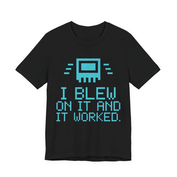 Black t-shirt printed in cyan ink with a pixel-art cartridge and the words “I Blew on It and It Worked.” in a blocky pixel font