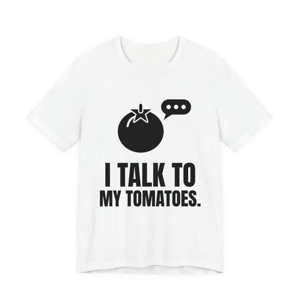 White t-shirt printed in dark ink with a tomato with a speech bubble and the words “I Talk to My Tomatoes.”