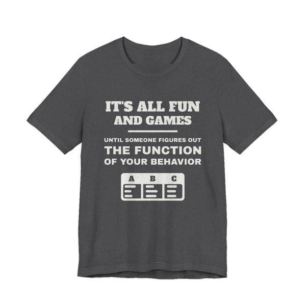 Dark Grey Heather t-shirt printed in off-white ink with an ABC data chart and the words “It's all fun and games until someone figures out the function of your behavior”