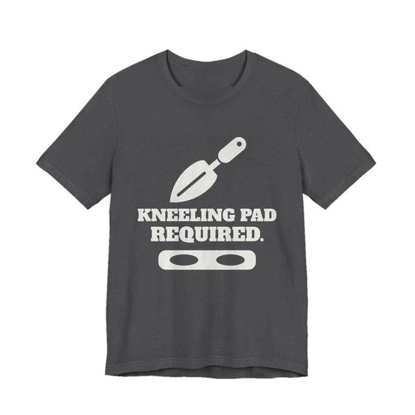 Dark Grey Heather t-shirt printed in off-white ink with a trowel, a kneeling pad and the words “Kneeling Pad Required.”