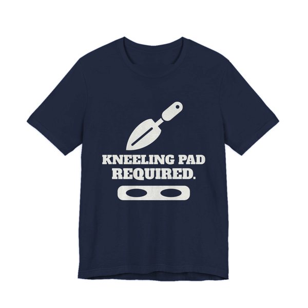 Navy t-shirt printed in off-white ink with a trowel, a kneeling pad and the words “Kneeling Pad Required.”