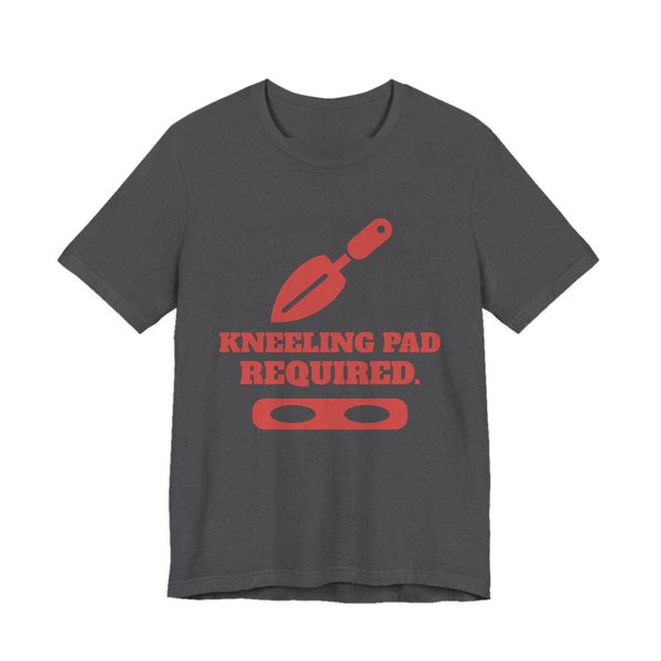 Dark Grey Heather t-shirt printed in tomato red ink with a trowel, a kneeling pad and the words “Kneeling Pad Required.”