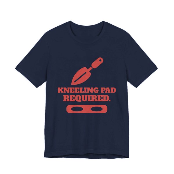 Navy t-shirt printed in tomato red ink with a trowel, a kneeling pad and the words “Kneeling Pad Required.”