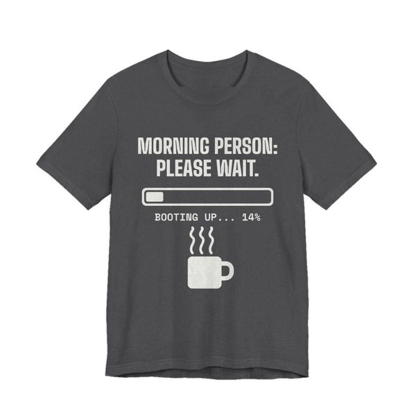 Dark Grey Heather t-shirt printed in off-white ink with a loading bar, a steaming mug and the words “Morning Person: Please Wait. Booting up... 14%”