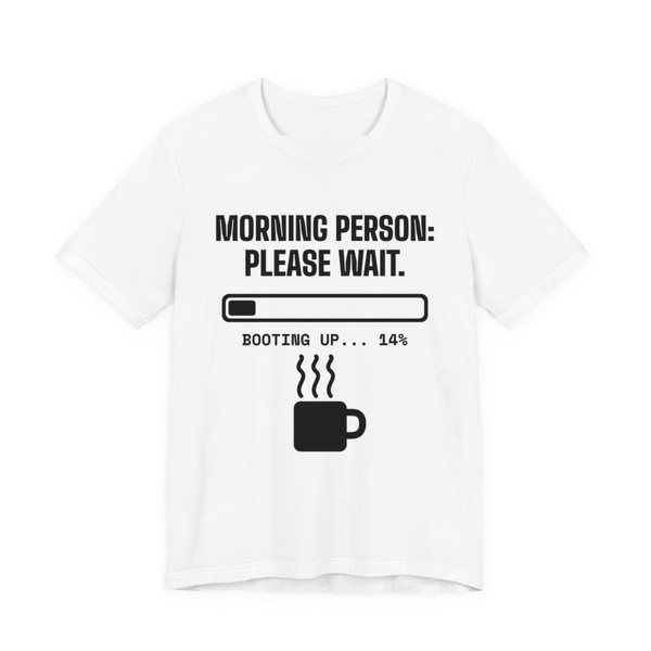 White t-shirt printed in dark ink with a loading bar, a steaming mug and the words “Morning Person: Please Wait. Booting up... 14%”