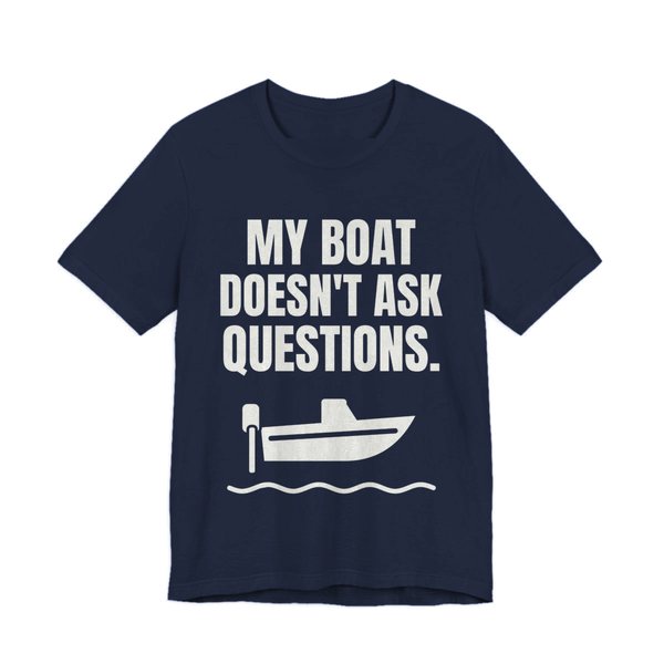 Navy t-shirt printed in off-white ink with a boat on the waves and the words “My Boat Doesn't Ask Questions.”