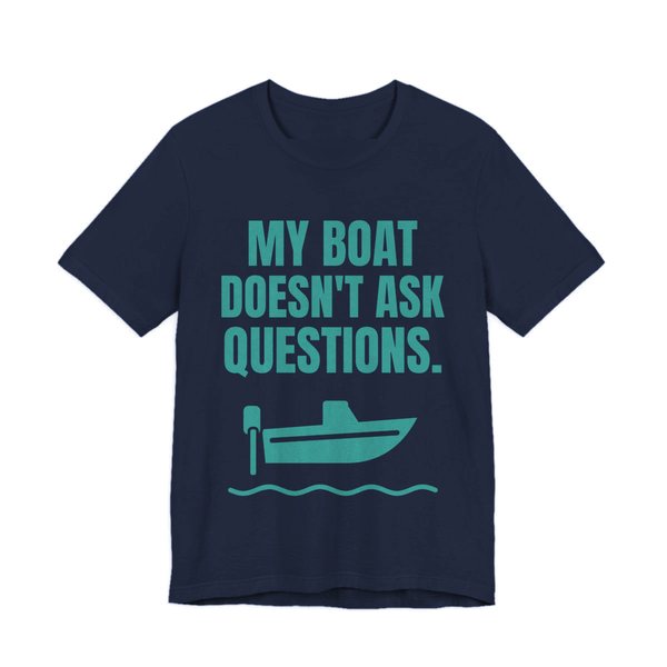 Navy t-shirt printed in teal ink with a boat on the waves and the words “My Boat Doesn't Ask Questions.”