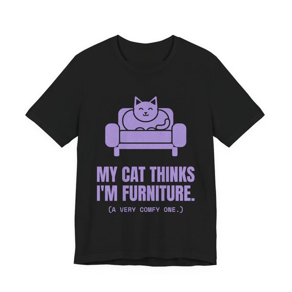 Black t-shirt printed in lavender ink with a cat on an armchair and the words “My Cat Thinks I'm Furniture.”