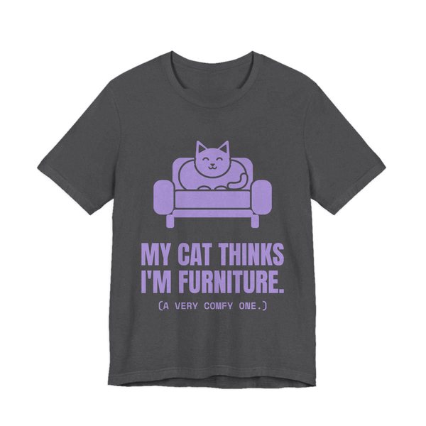 Dark Grey Heather t-shirt printed in lavender ink with a cat on an armchair and the words “My Cat Thinks I'm Furniture.”