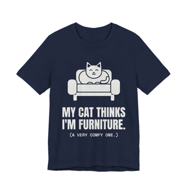 Navy t-shirt printed in off-white ink with a cat on an armchair and the words “My Cat Thinks I'm Furniture.”