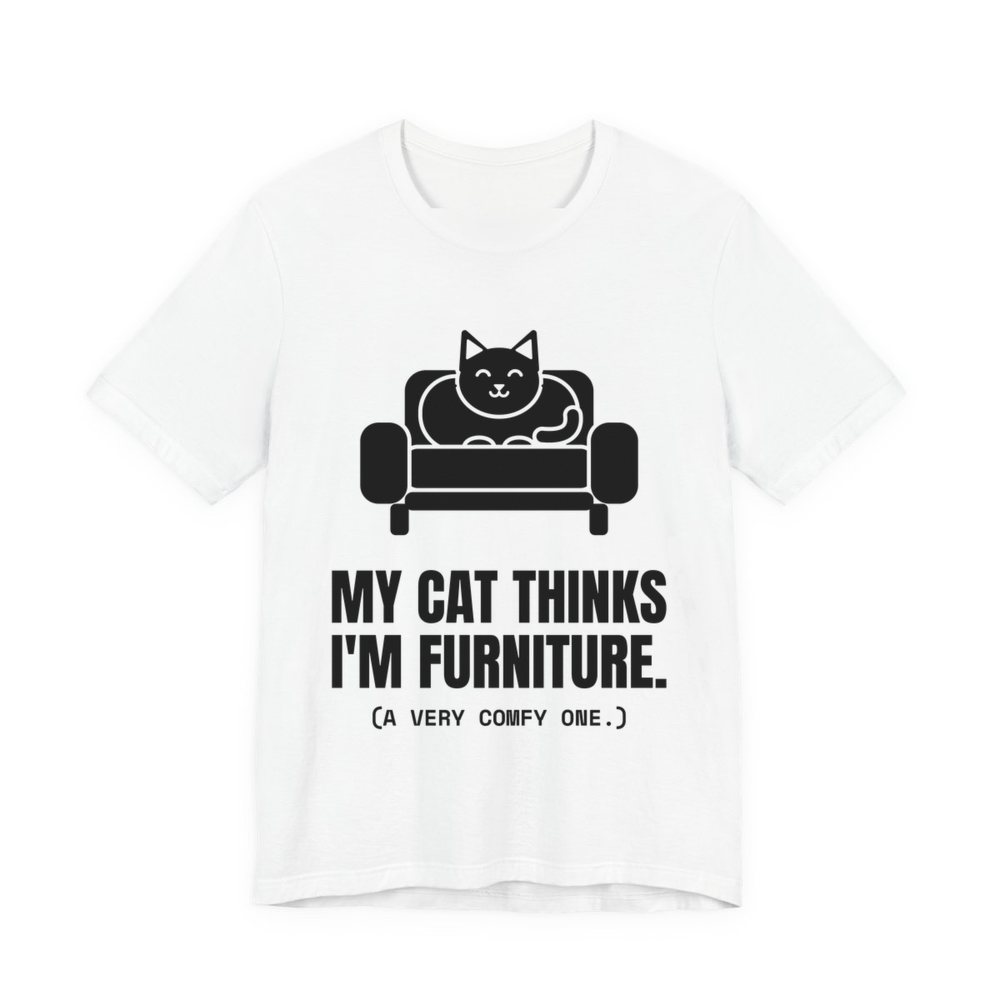 White t-shirt printed in dark ink with a cat on an armchair and the words “My Cat Thinks I'm Furniture.”
