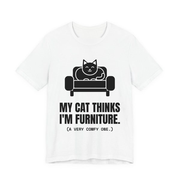 White t-shirt printed in dark ink with a cat on an armchair and the words “My Cat Thinks I'm Furniture.”