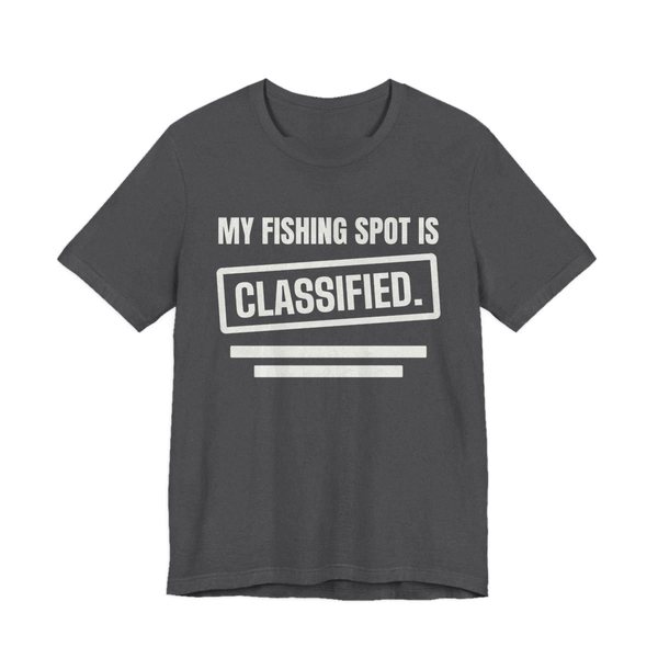 Dark Grey Heather t-shirt printed in off-white ink with a stamp box, redaction bars and the words “My Fishing Spot Is Classified.”