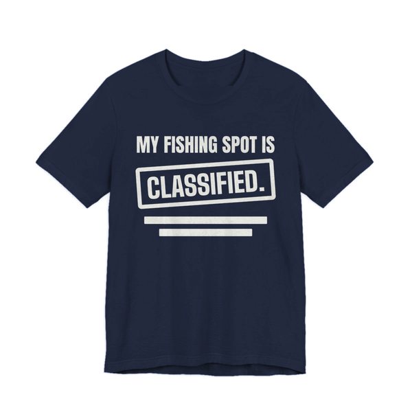 Navy t-shirt printed in off-white ink with a stamp box, redaction bars and the words “My Fishing Spot Is Classified.”